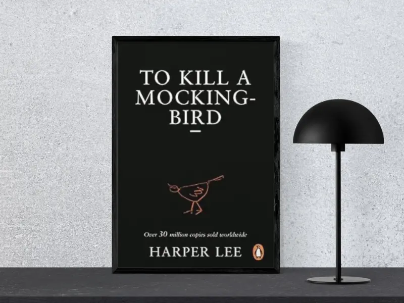 To Kill a Mockingbird by Harper Lee Book cover of To Kill a Mockingbird by Harper Lee, displayed in a black frame next to a modern black lamp, highlighting one of the good books to read fiction.