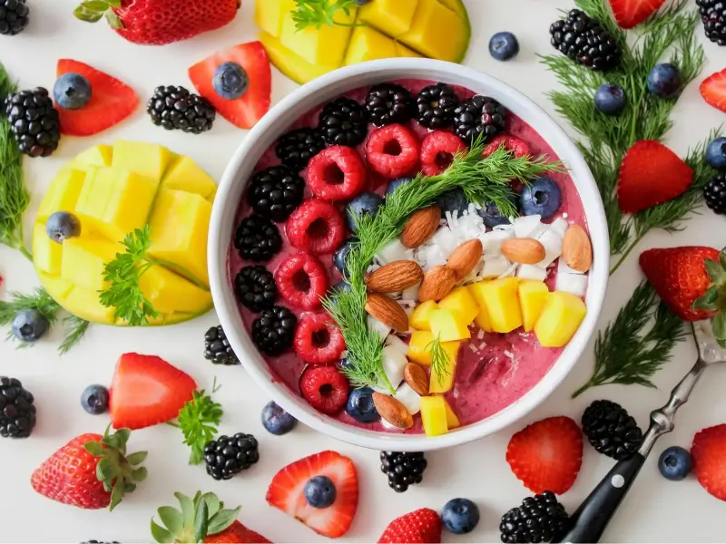 Eat to Beat Disease Diet There is a bowl loaded with fruits, strawberry, blackberry, almonds, cherry, pineapple. Diet and balanced food suggested in eat to beat disease book by dr. Li William