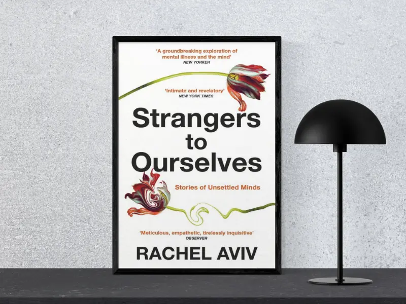 Strangers to Ourselves by Rachel Aviv Book cover of Strangers to Ourselves: Unsettled Minds and the Stories That Make Us by Rachel Aviv, featuring the subtitle ‘Tiny Changes Remarkable Results’, displayed in a black frame next to a modern black lamp, highlighting.