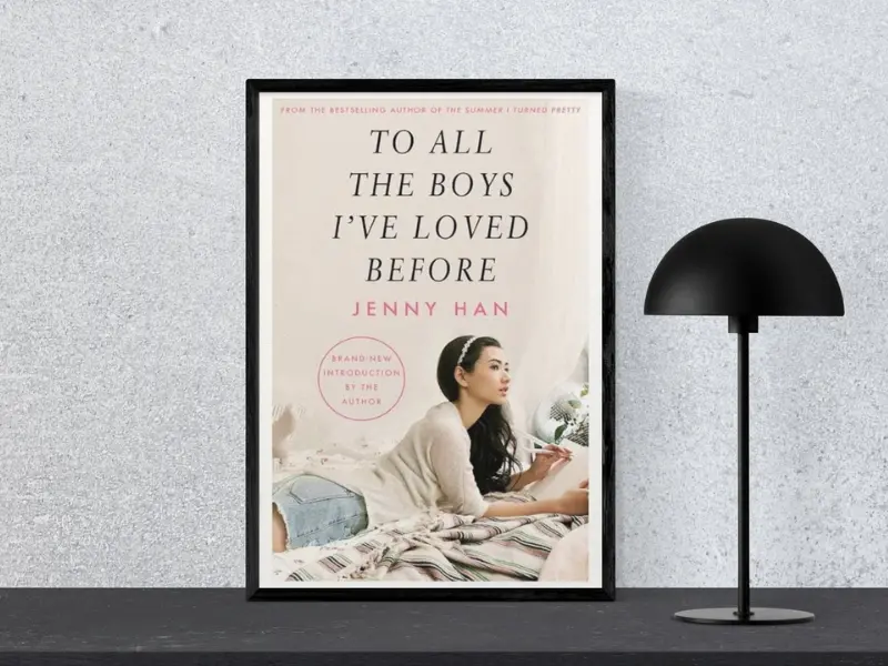 To All The Boys I've Loved Before by Jenny Han Book cover of To All The Boys I've Loved Before by Jenny Han, displayed in a black frame next to a modern black lamp, showcasing a sweet and relatable teenage love story — one of the best romantic novels for teens.