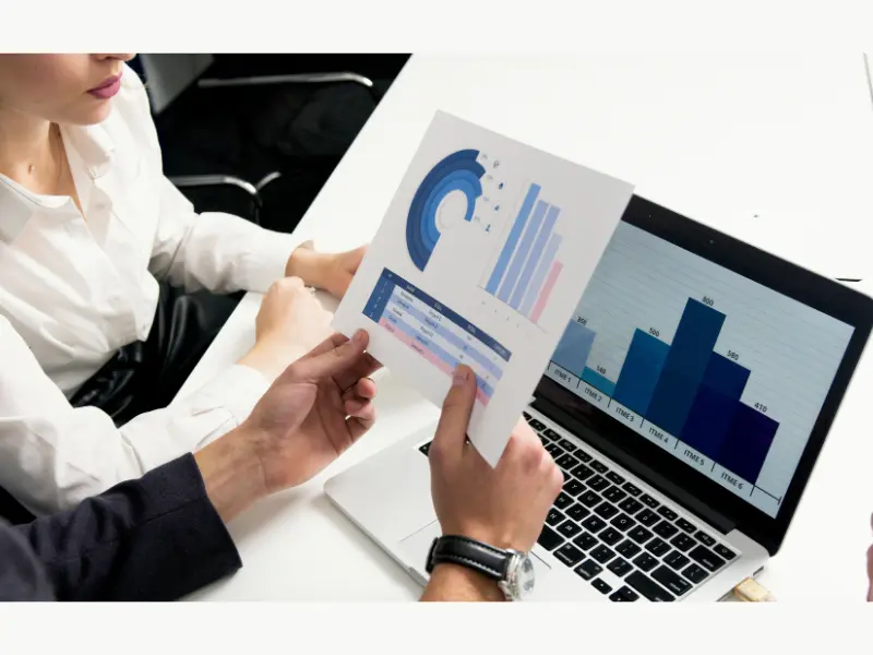 People analyzing investment charts and business reports related to the Coffee Can Investing book