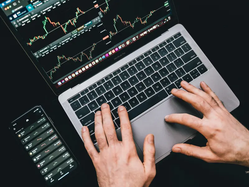 Stock market graphs on laptop screen showing analysis inspired by the Coffee Can Investing book